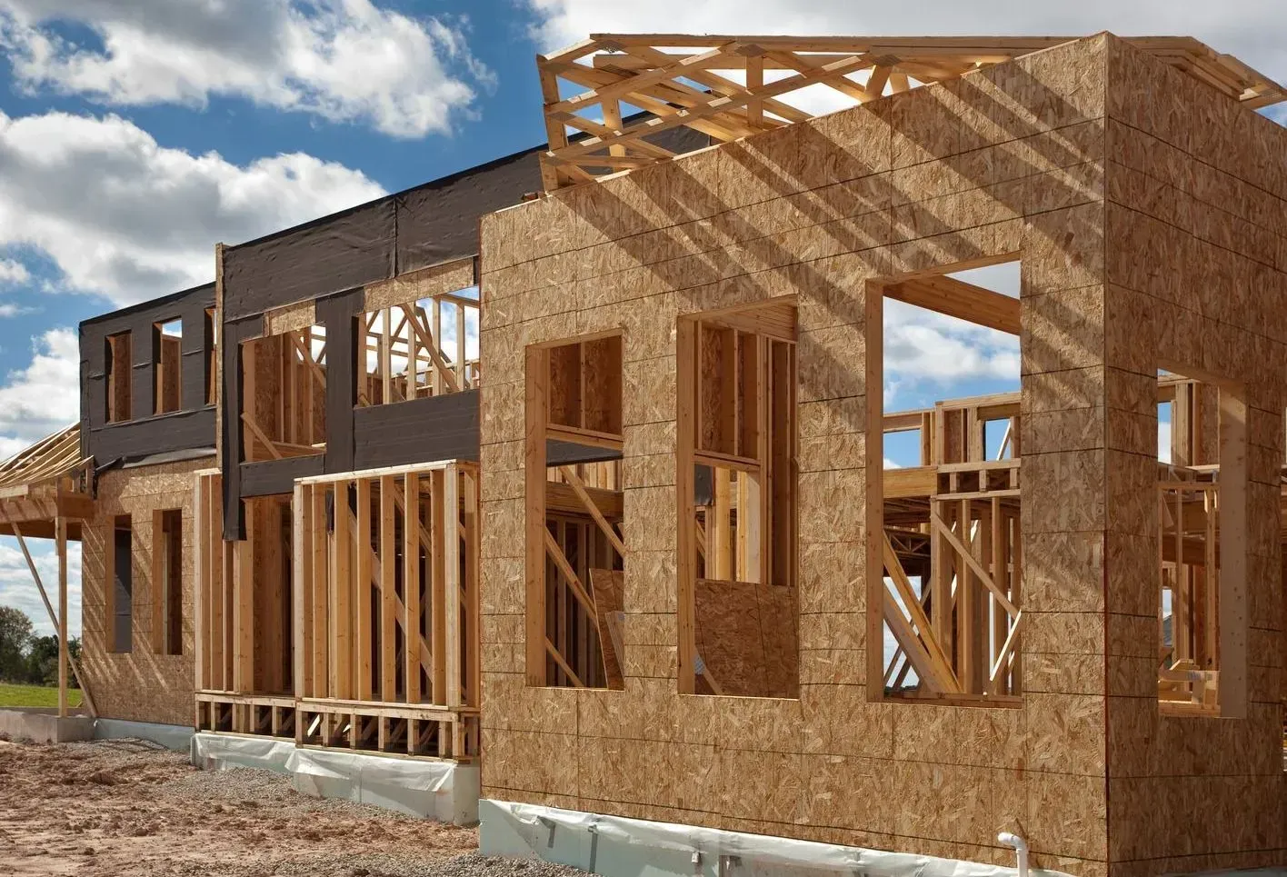 A large wooden house is being built in the desert.