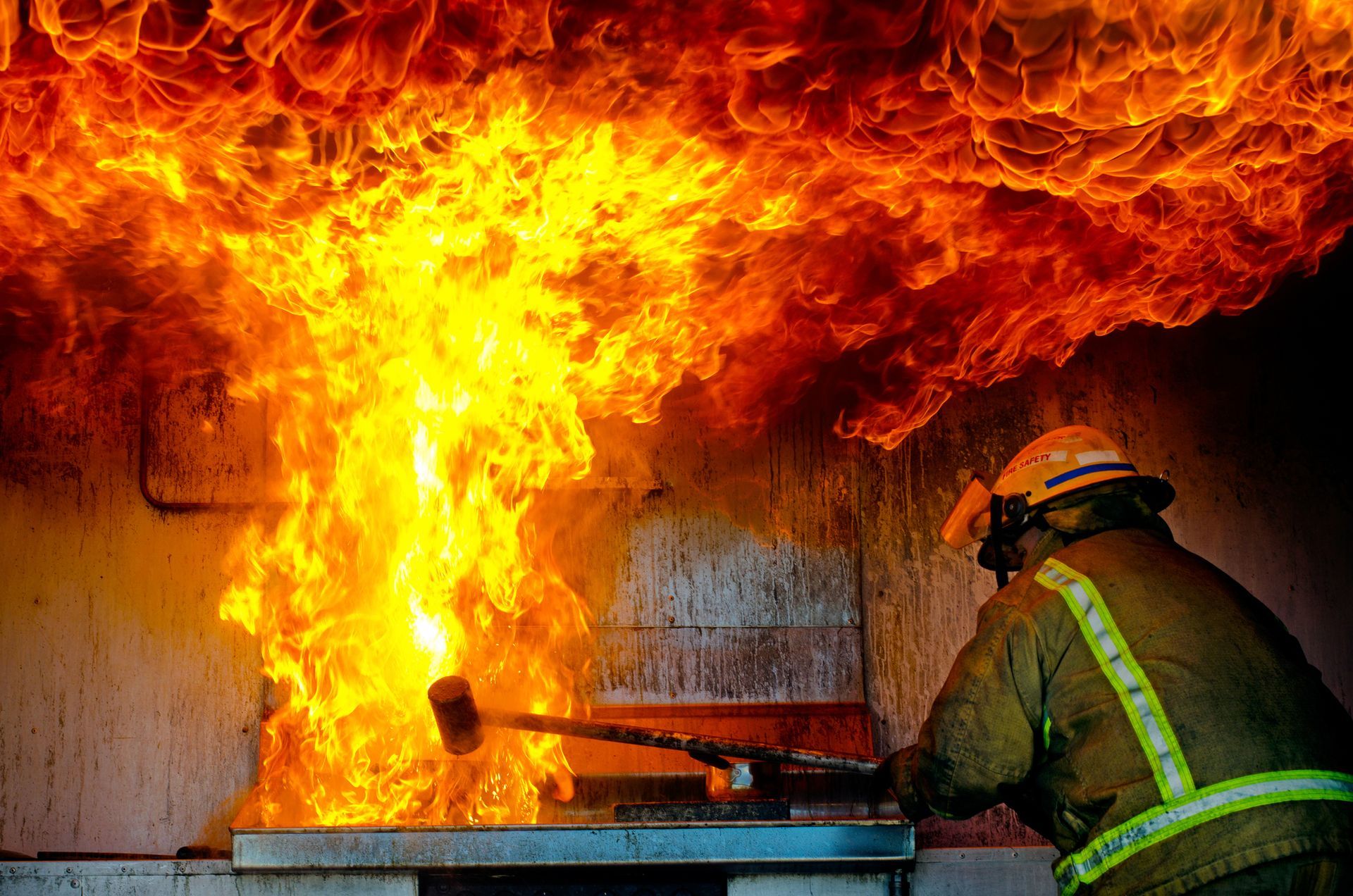 a fireman is using a hammer to put out a fire
