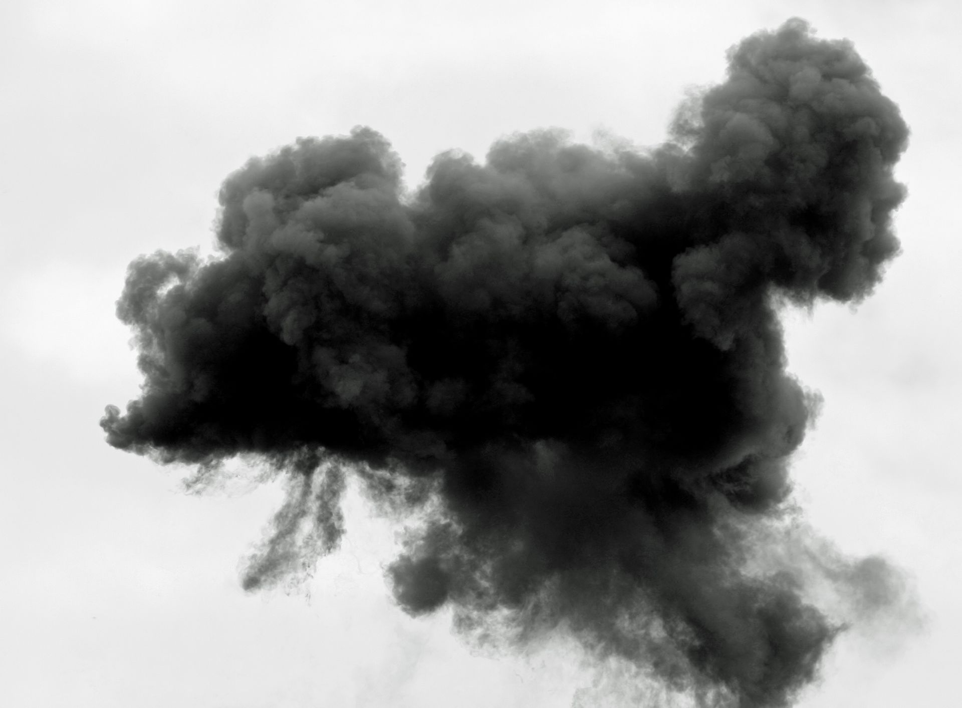 a large cloud of black smoke against a white background