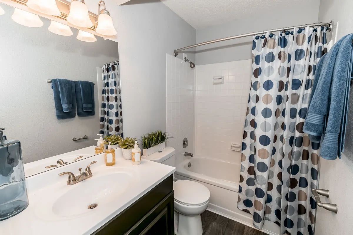 a bathroom with a polka dot shower curtain
