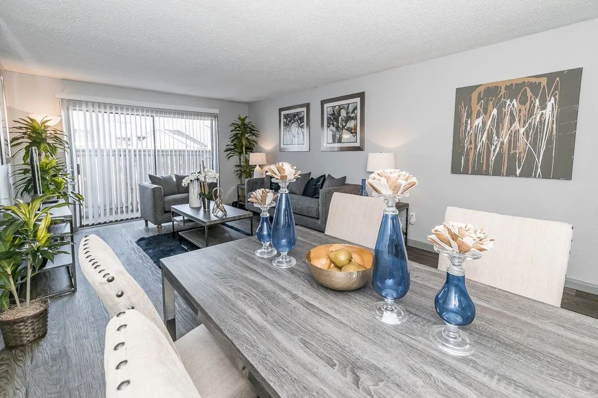 a living room with a dining table and chairs