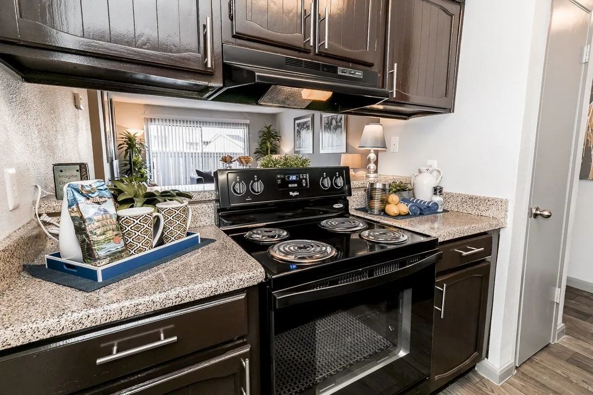 a kitchen with a black stove top oven and black cabinets