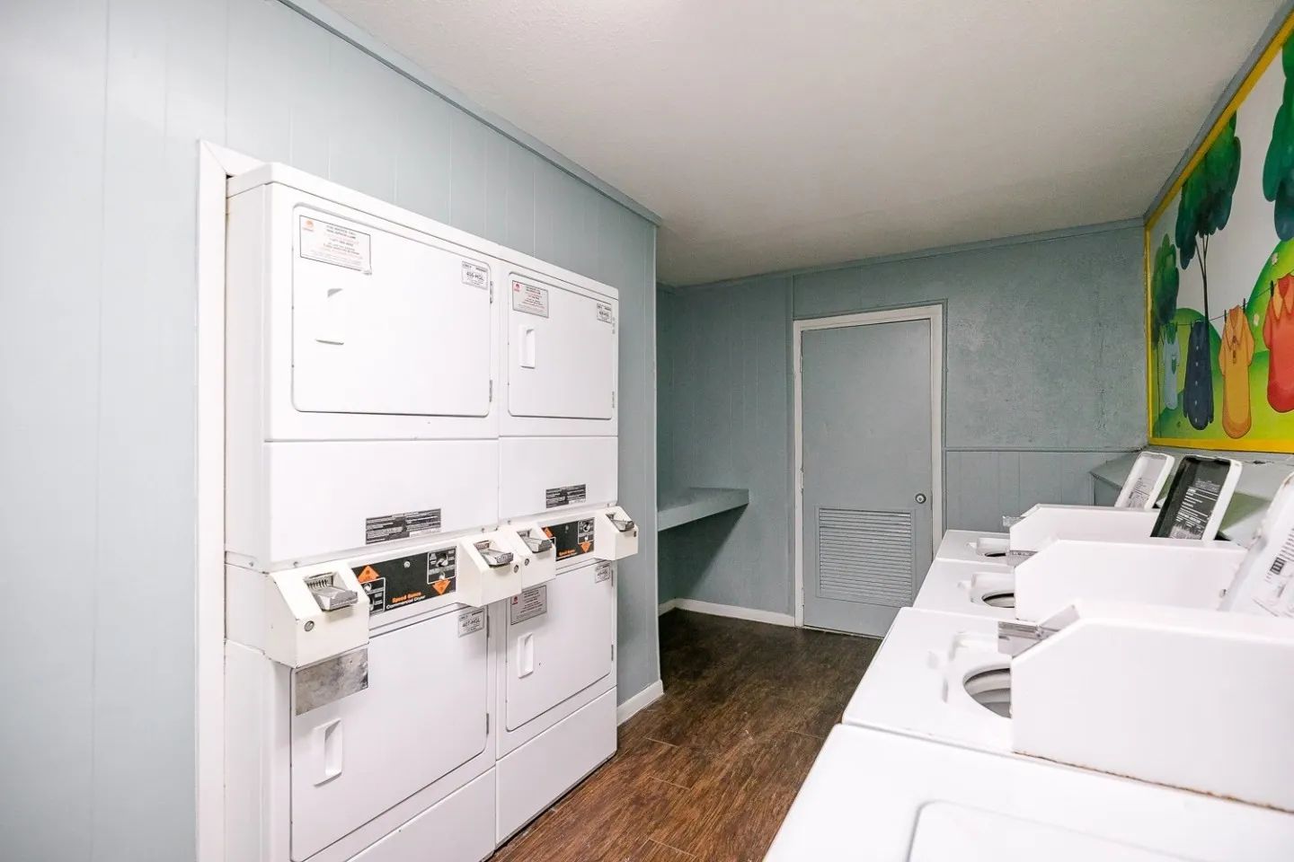 a laundromat with washers and dryers stacked on top of each other