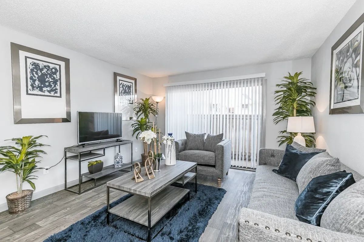 a living room with a couch a chair and a flat screen tv