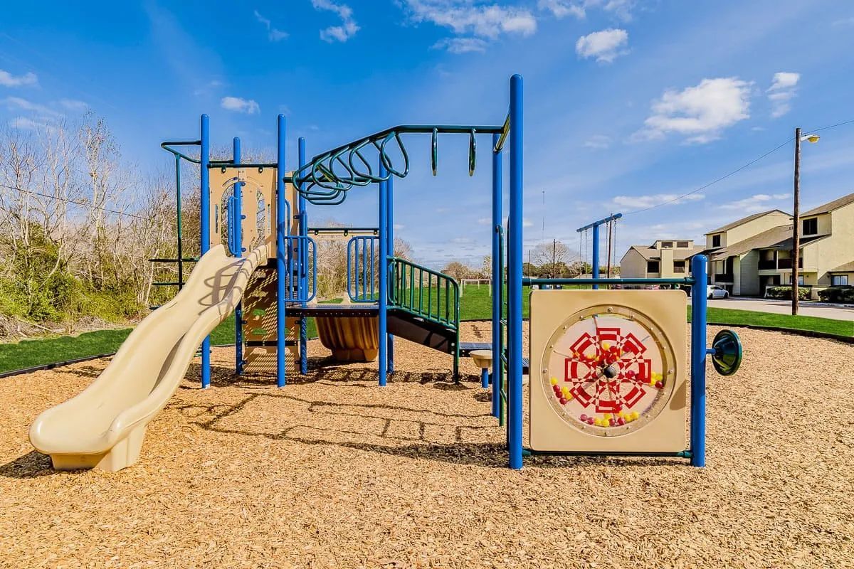 a playground with a slide and a clock on it