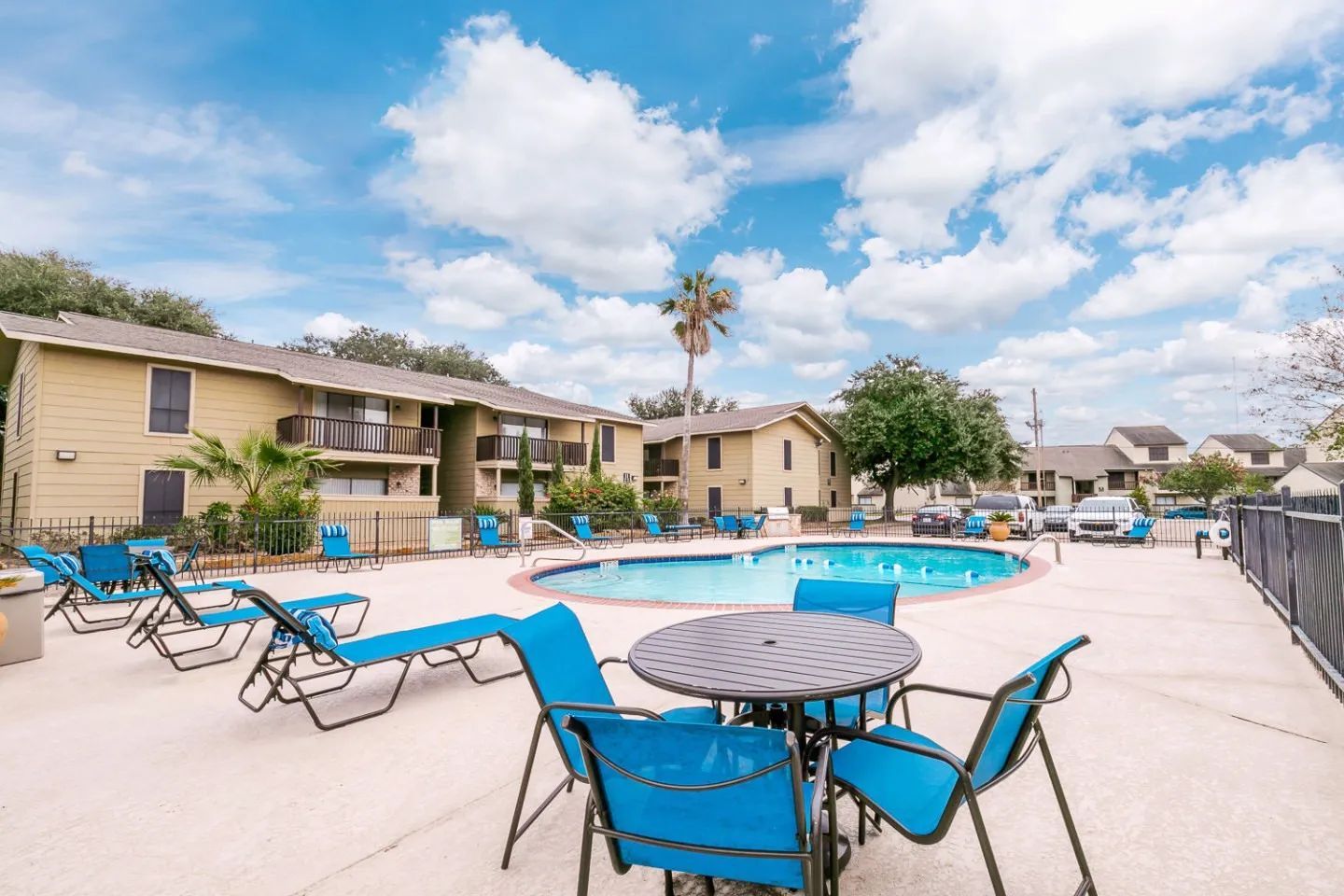 a swimming pool with a table and chairs around it