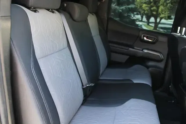 The back seats of a truck are gray and black