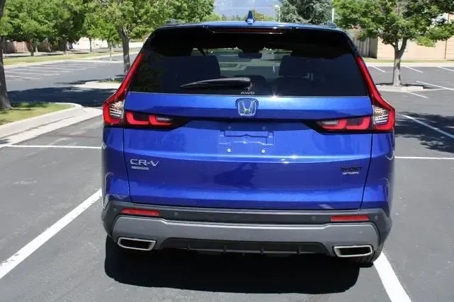 A blue honda cr v is parked in a parking lot