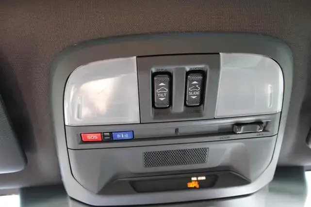 A close up of a ceiling light in a car.