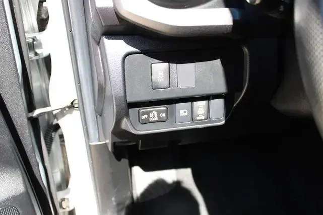 A close up of a car dashboard with a few buttons on it.