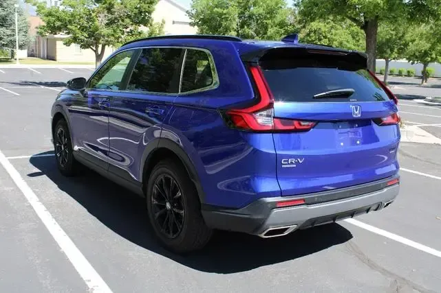 A blue honda cr v is parked in a parking lot.