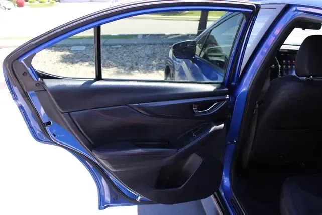 The back door of a blue car is open