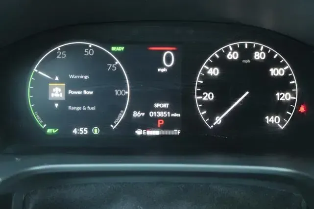A close up of a car dashboard with a speedometer and a tachometer