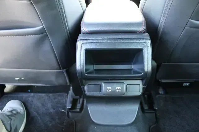 A person is sitting in the back seat of a car.