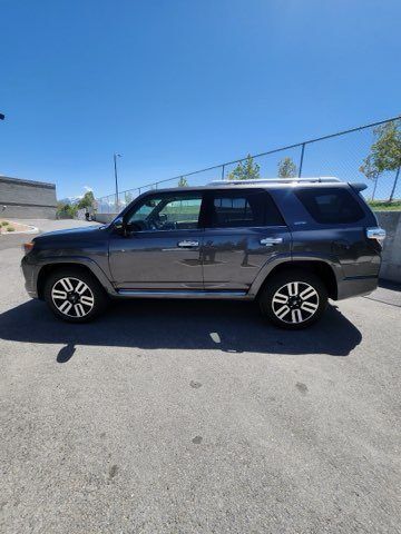 A toyota 4runner is parked in a parking lot on a sunny day.
