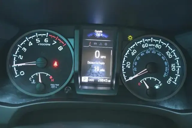 A close up of a car dashboard with a digital display