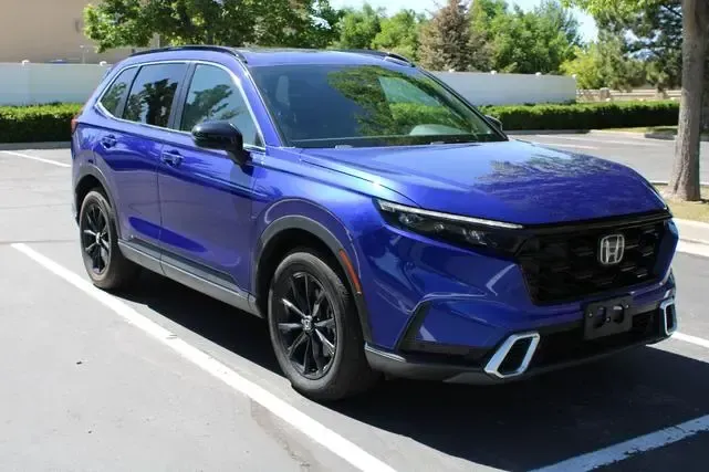 A blue honda accord is parked in a parking lot.