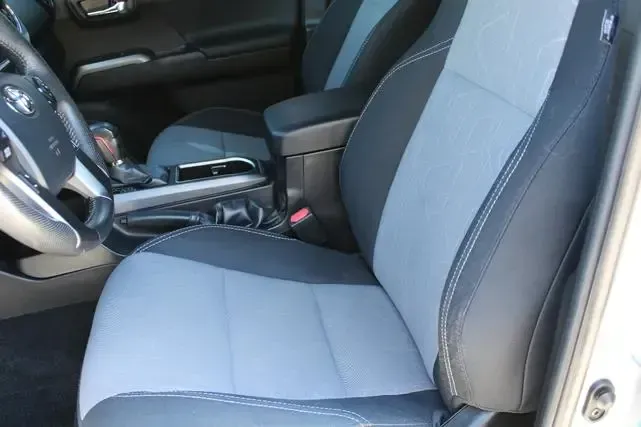 The front seats of a toyota tacoma are gray and black.