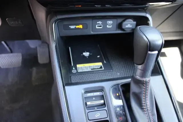 A car with a wireless charger in the center console.