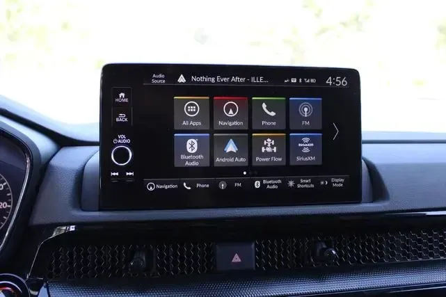 A car radio is sitting on the dashboard of a car.