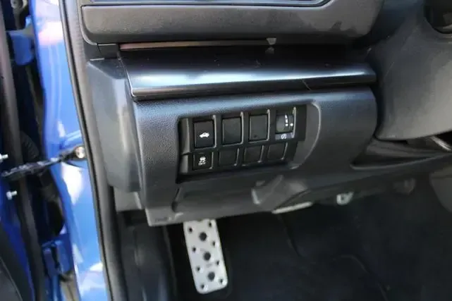 A close up of a car 's dashboard with a few buttons on it.