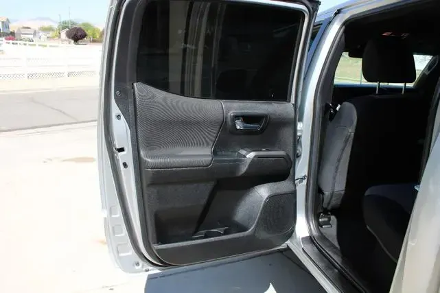 The inside of a silver truck with the door open.