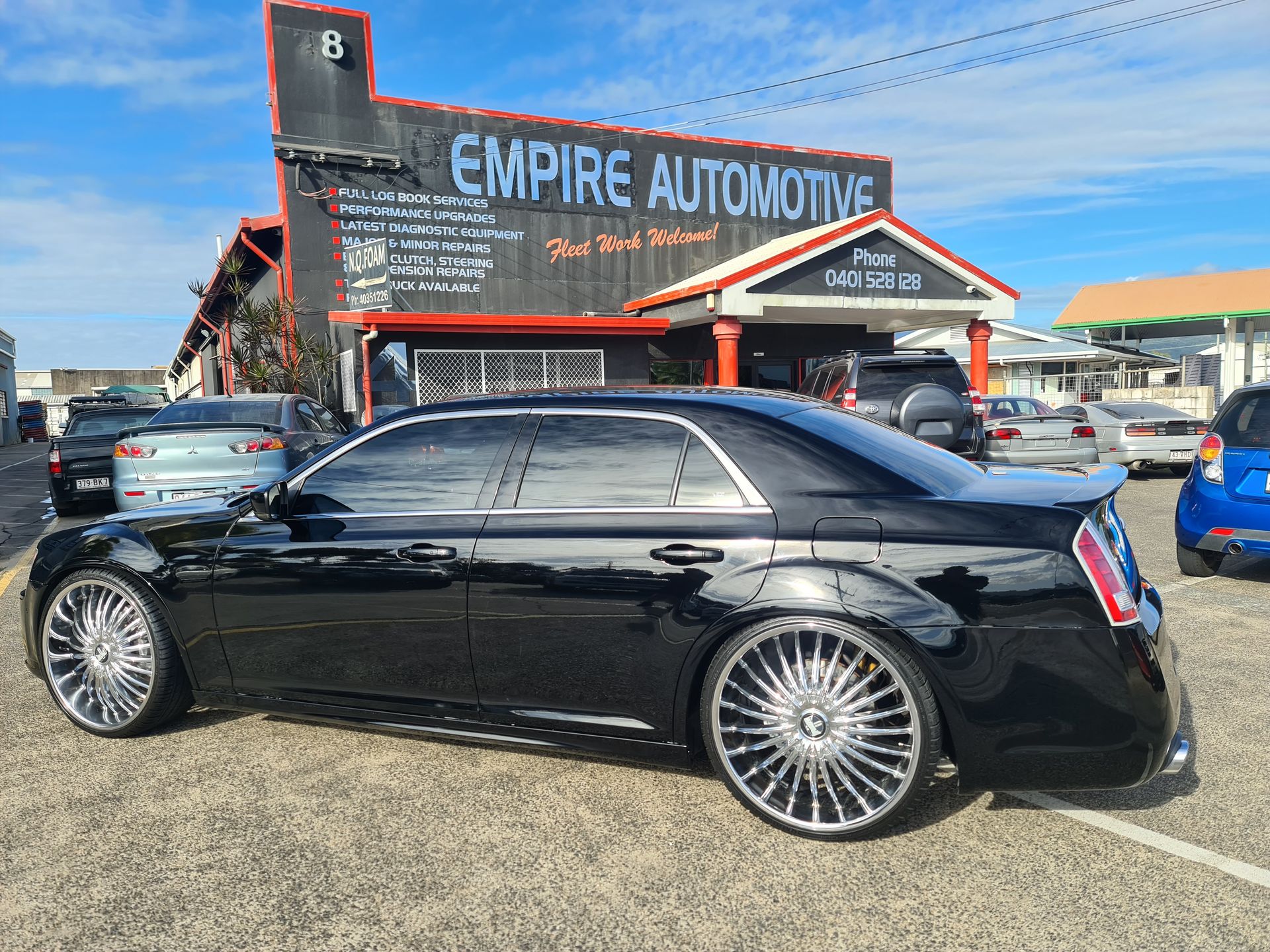 A Silver Car is Parked in Front of a Car Dealership — Empire Automotive In Portsmith, QLD