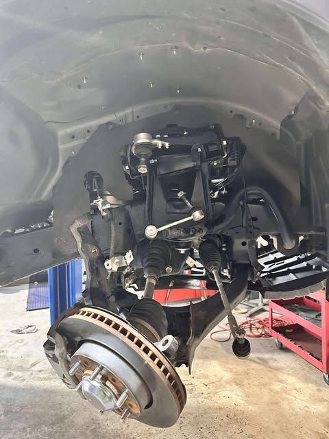 A Person is Working on a Motorcycle With a Wrench and Brush — Empire Automotive In Portsmith, QLD