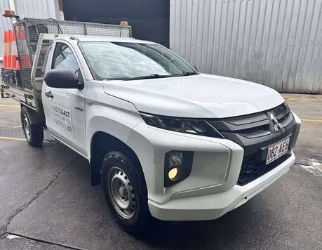 Three Cars Are Parked Next to Each Other in a Dark Room — Empire Automotive In Portsmith, QLD
