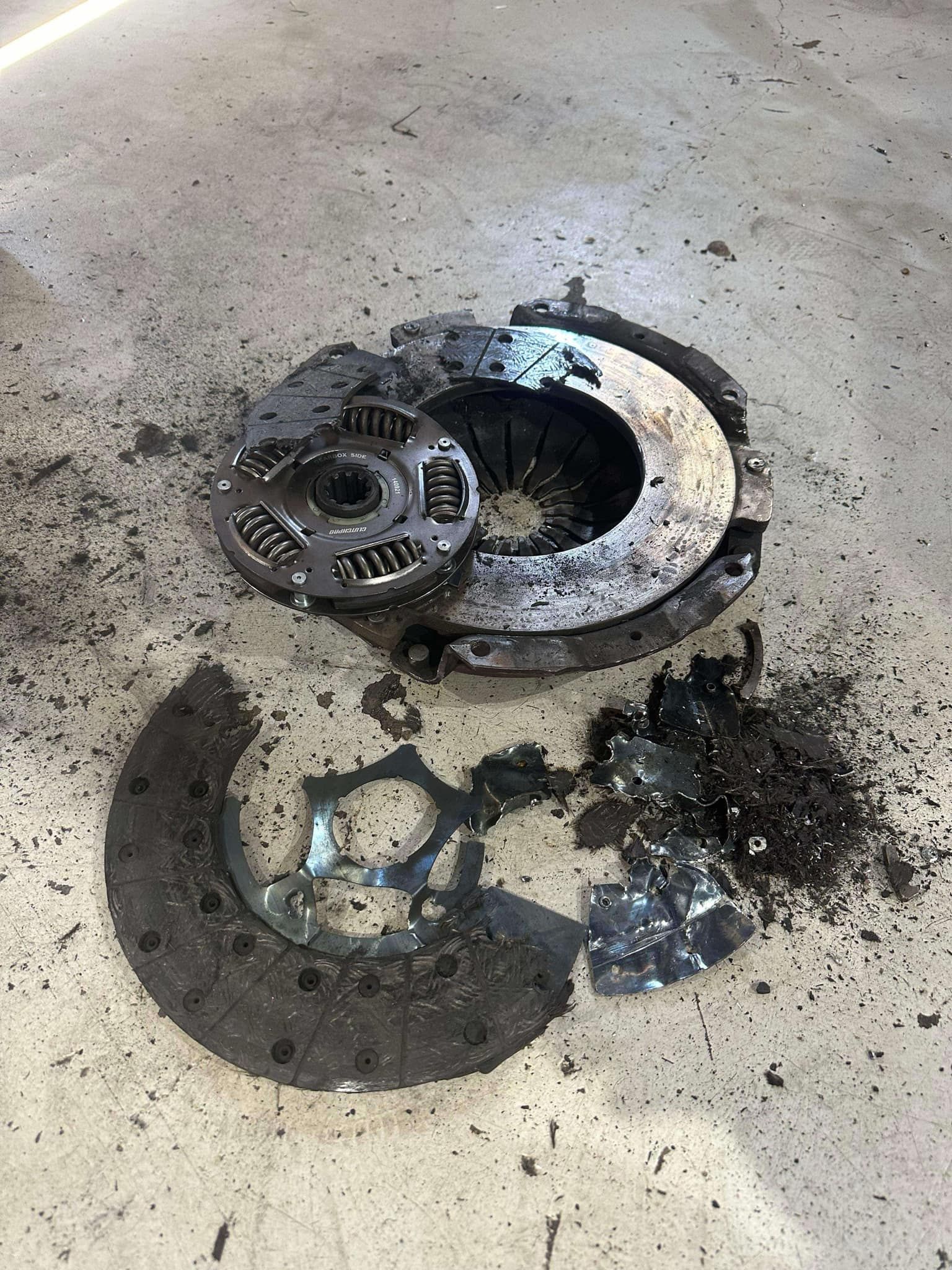 A Man is Working on a Car Clutch With a Wrench — Empire Automotive In Portsmith, QLD