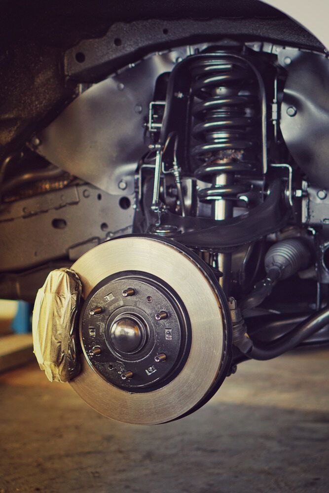 A Close Up of a Car 's Suspension and Brake System — Empire Automotive In Portsmith, QLD