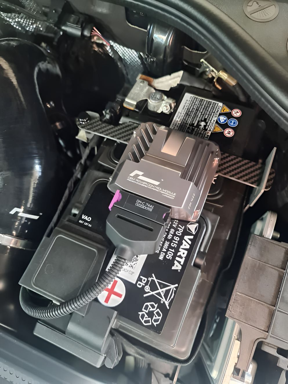 A Car Battery is Sitting Under the Hood of a Car — Empire Automotive In Portsmith, QLD