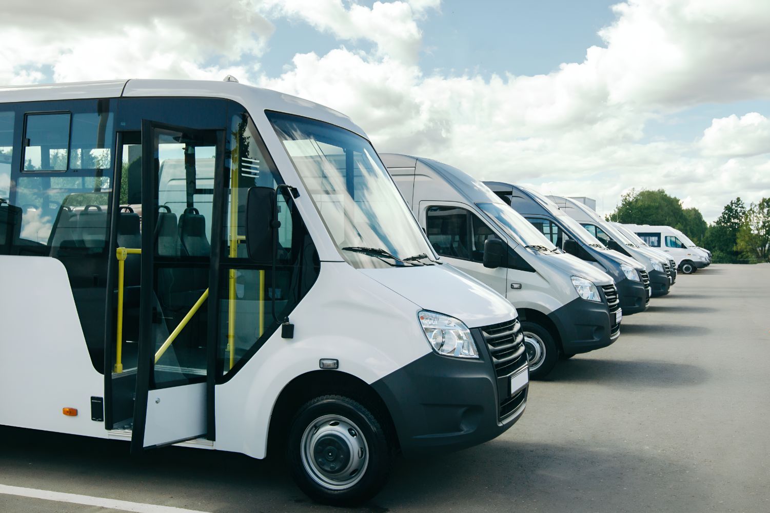 A Row of White Vans Are Parked in a Parking Lot — Empire Automotive In Portsmith, QLD