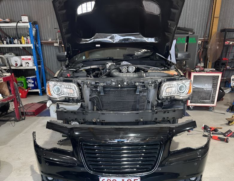 A Black Car With the Hood Open is Being Worked on in a Garage. — Empire Automotive In Portsmith, QLD