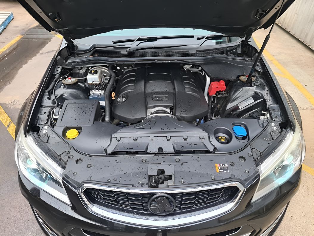 A Black Car With the Hood Up is Parked in a Parking Lot — Empire Automotive In Portsmith, QLD
