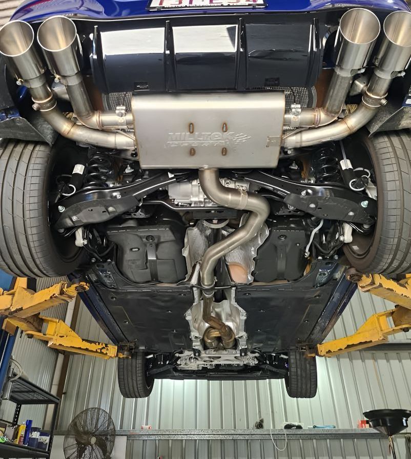 A Blue Car is Sitting on a Lift in a Garage — Empire Automotive In Portsmith, QLD