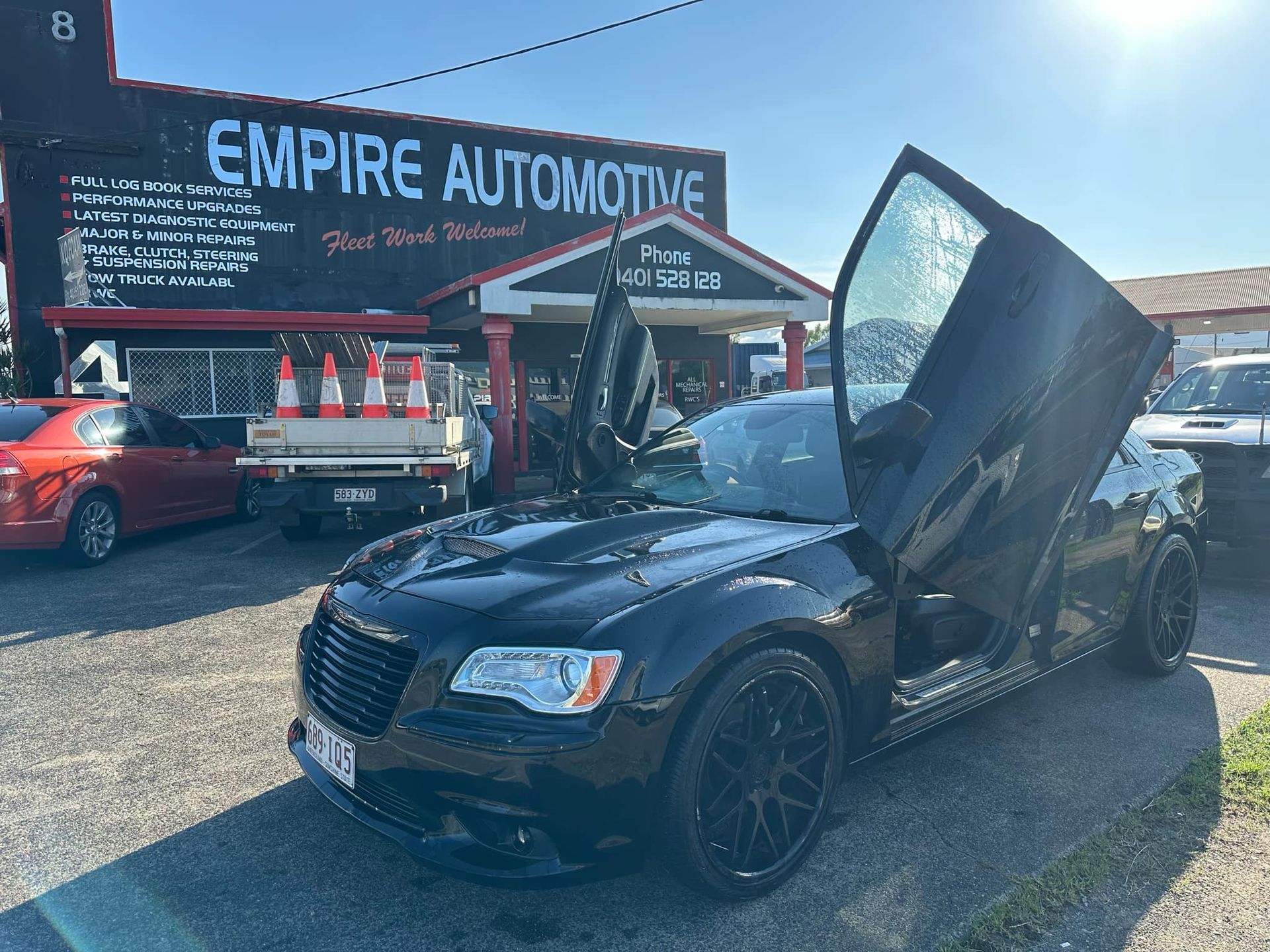 A Man is Working on the Engine of a Truck — Empire Automotive In Portsmith, QLD