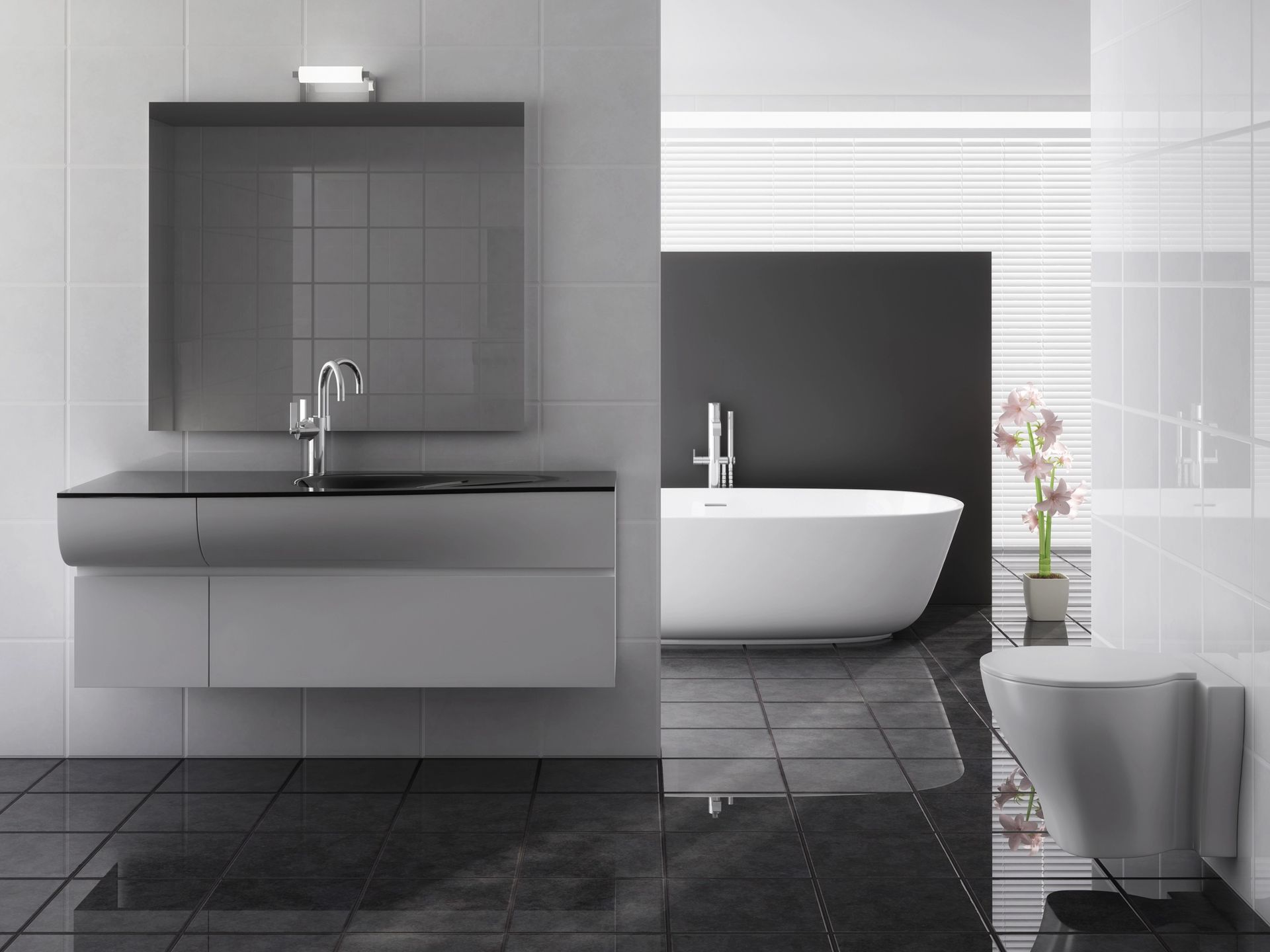 Bagno moderno con mobile lavabo sospeso, vasca da bagno e WC; combinazione di colori grigio e nero.