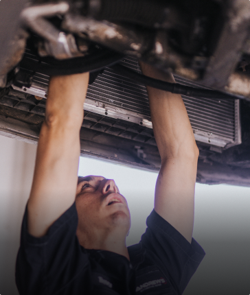 Technician performing cooling system service on vehicle | Andrew's Automotive Repair