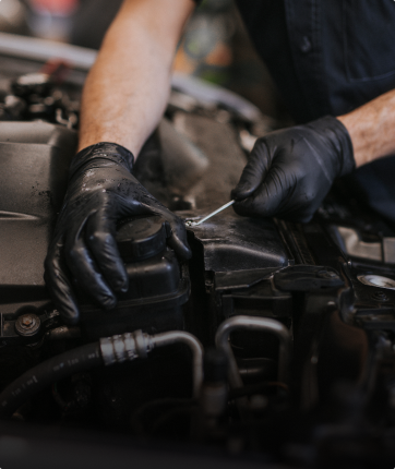 Technician performing vehicle maintenance | Andrew's Automotive Repair