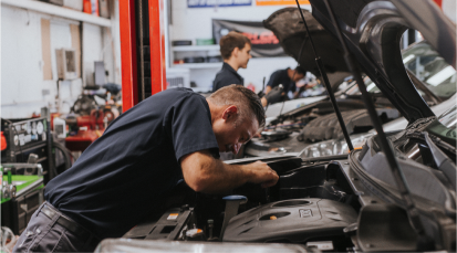Technician working under hood of car | Andrew's Automotive Repair