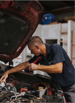 Technician working under hood of car | Andrew's Automotive Repair