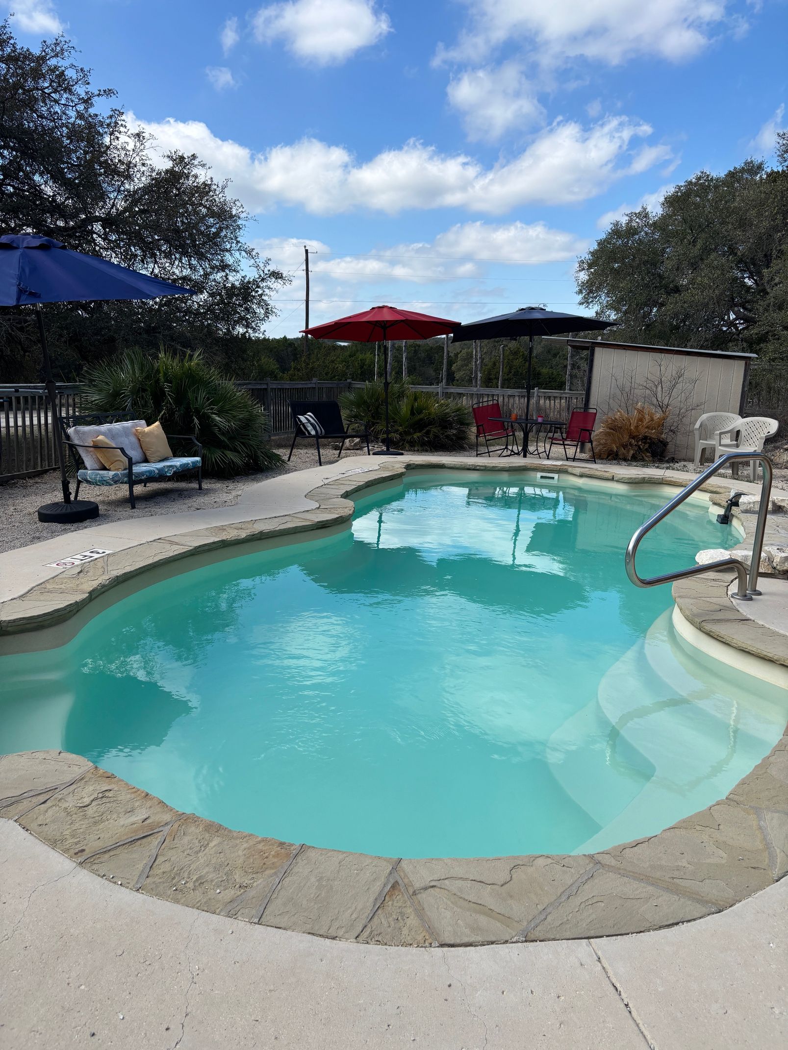 A large swimming pool in front of a house