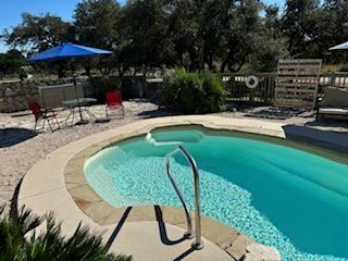 A large swimming pool in front of a house