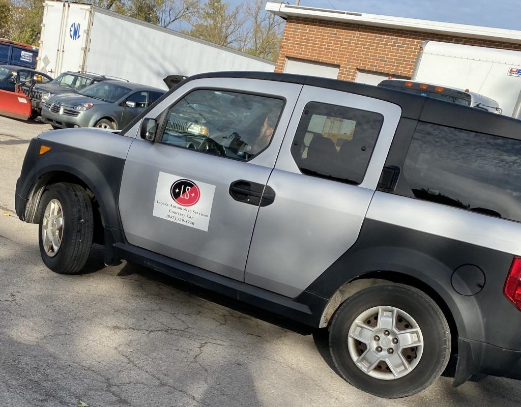Silver Honda Element pickup truck with black fenders, parked outside. | Loyola Service