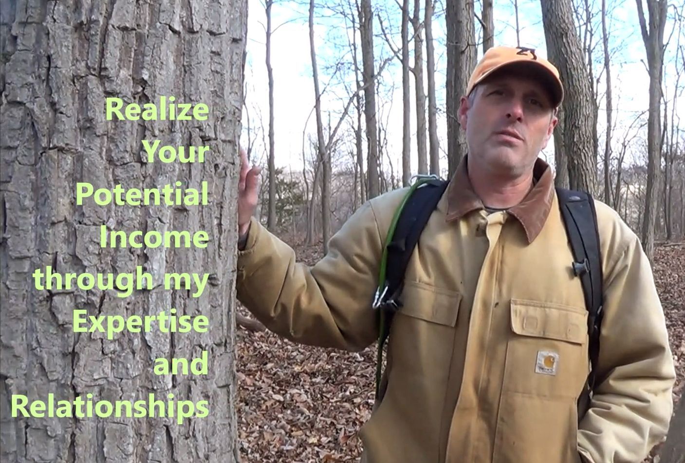 j neutzel standing by tree with words about his work