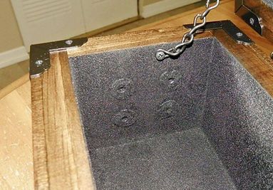 A wooden box with a chain hanging from it.