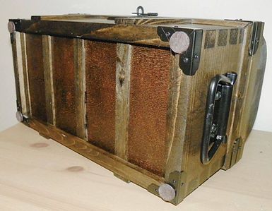 The bottom of a wooden box with metal handles