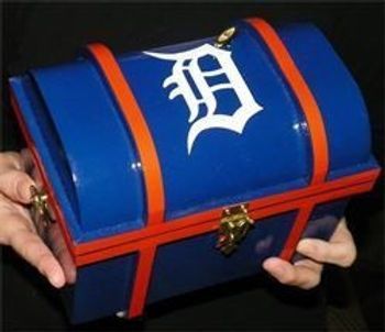 A person is holding a blue chest with a detroit logo on it