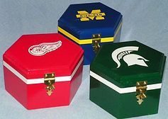 Three boxes with logos on them are sitting next to each other on a table.